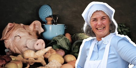 Elever der står med æbler ved træborde på Greve Museum, mens der går en dame rundt i udklædning